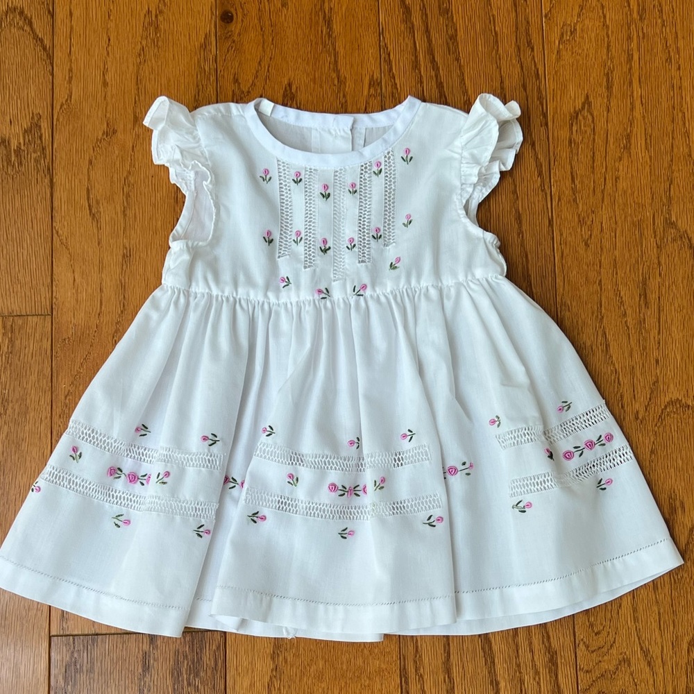 Hand embroidered white dress with pink embroidered flower